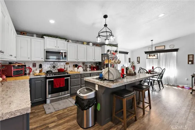 a bathroom with a granite countertop sink mirror vanity and toilet