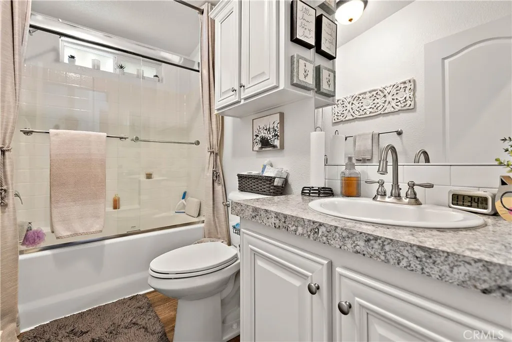 8651 Foothill, Unit 82 Rancho Cucamonga, CA 91730 - Photo 26 of 56 a bathroom with a granite countertop sink mirror vanity and toilet