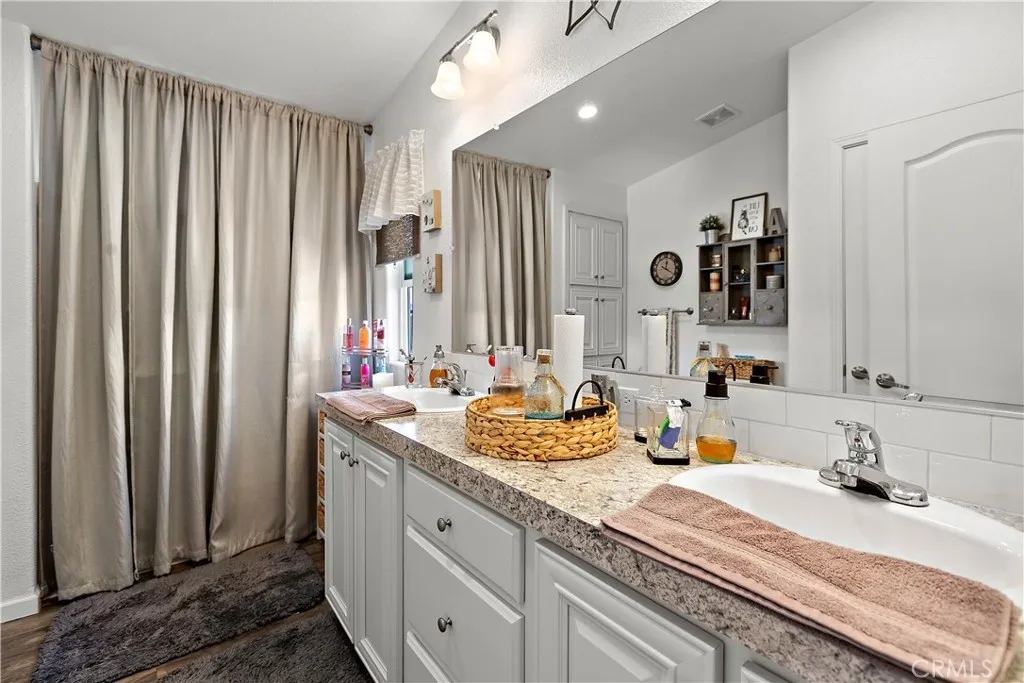 8651 Foothill, Unit 82 Rancho Cucamonga, CA 91730 - Photo 37 of 56 a bathroom with double vanity sinks a vanity and a mirror