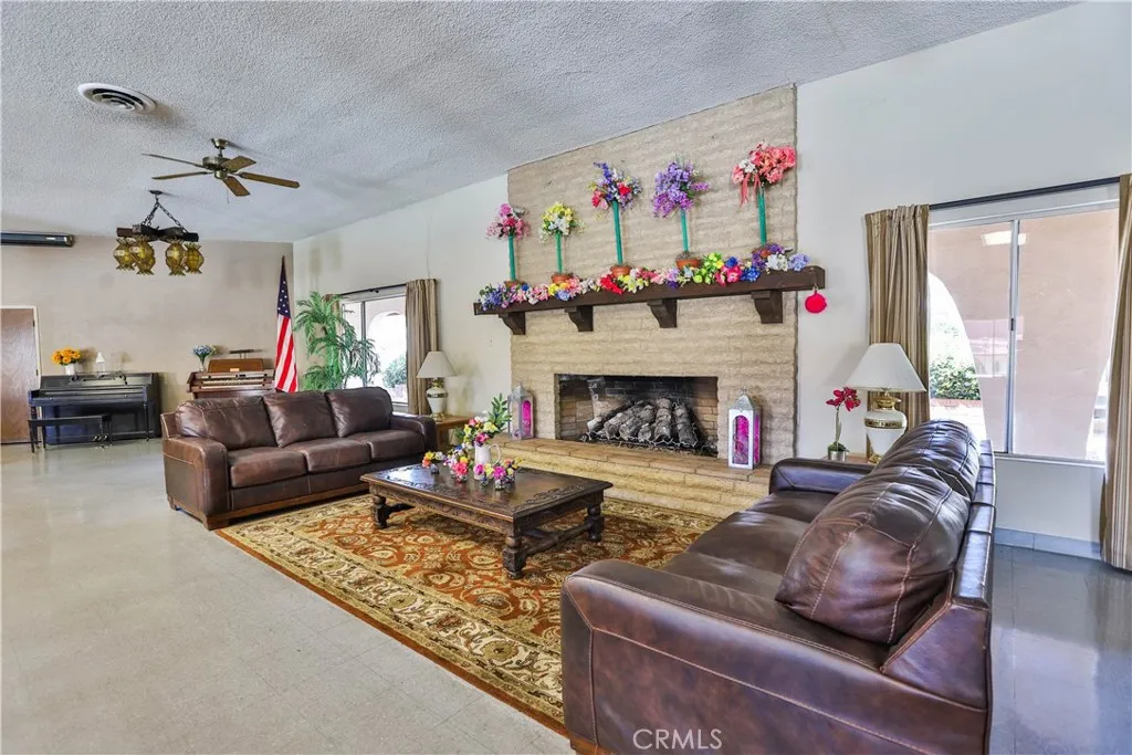 8651 Foothill, Unit 82 Rancho Cucamonga, CA 91730 - Photo 48 of 56 a living room with furniture and a fireplace