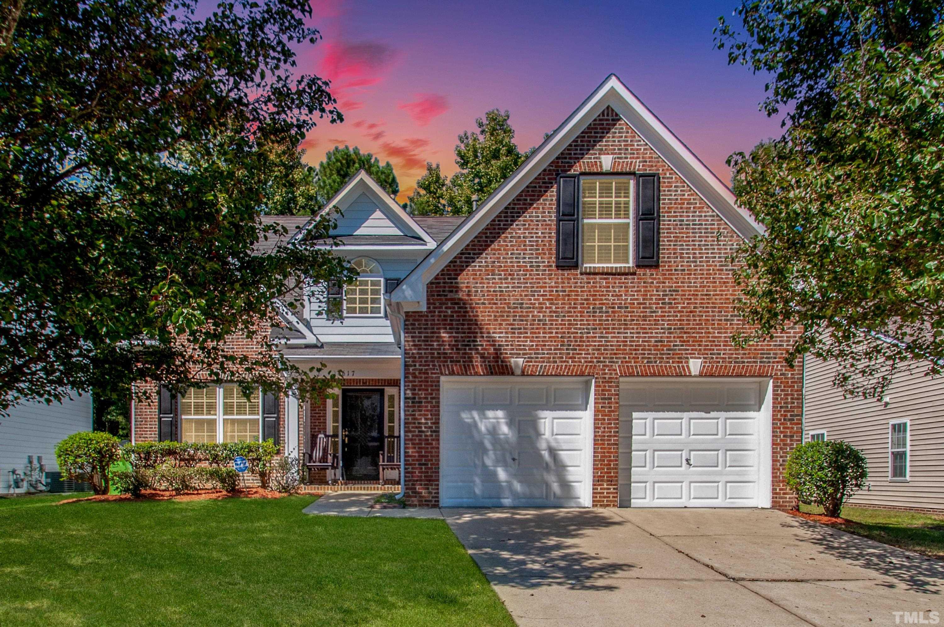4617 Dresden Village Drive Raleigh, NC 27604 - Photo 1 of 33 a front view of a house with a garden and plants