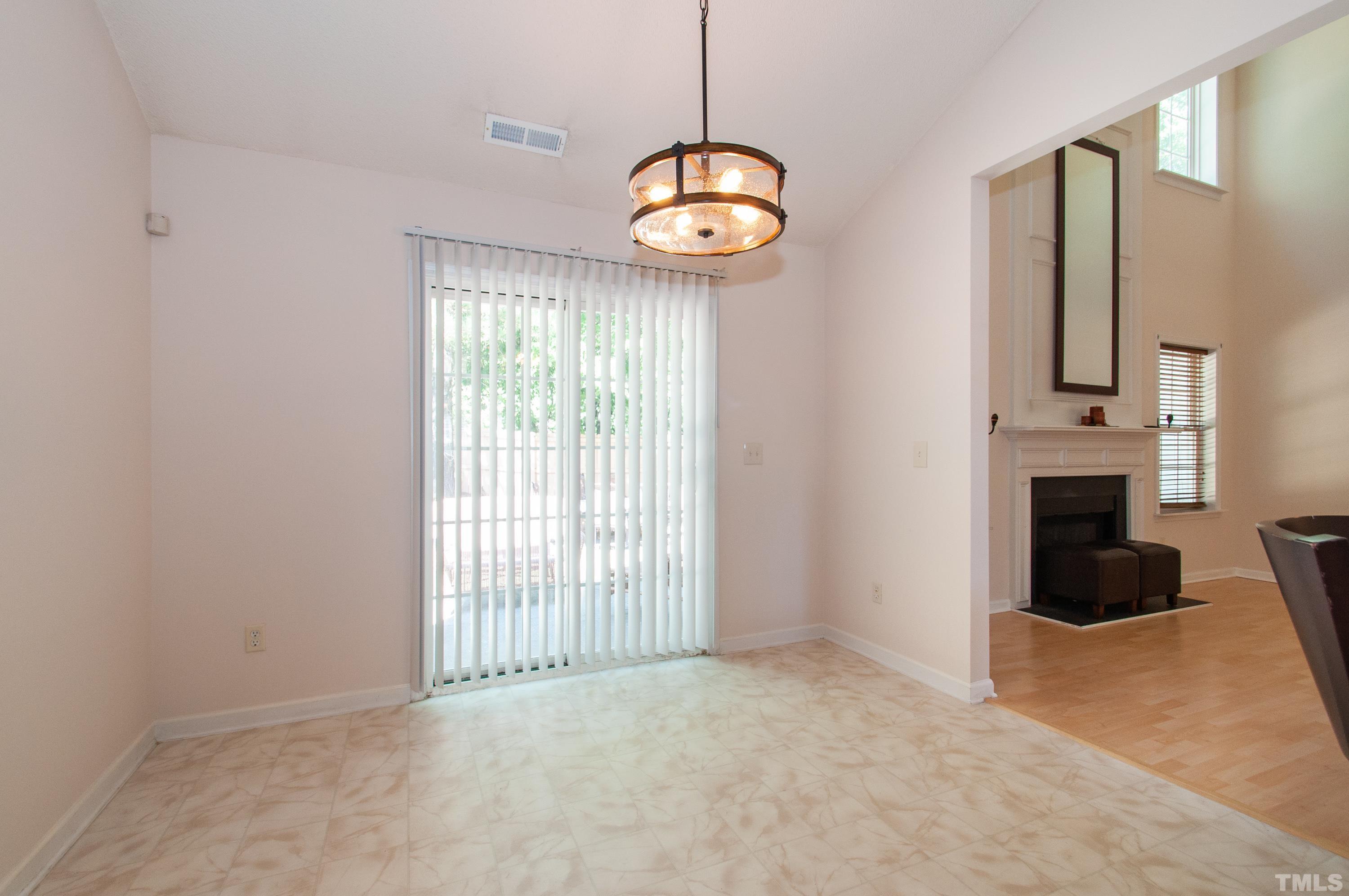 4617 Dresden Village Drive Raleigh, NC 27604 - Photo 13 of 33 a view of an empty room with a fireplace and a window