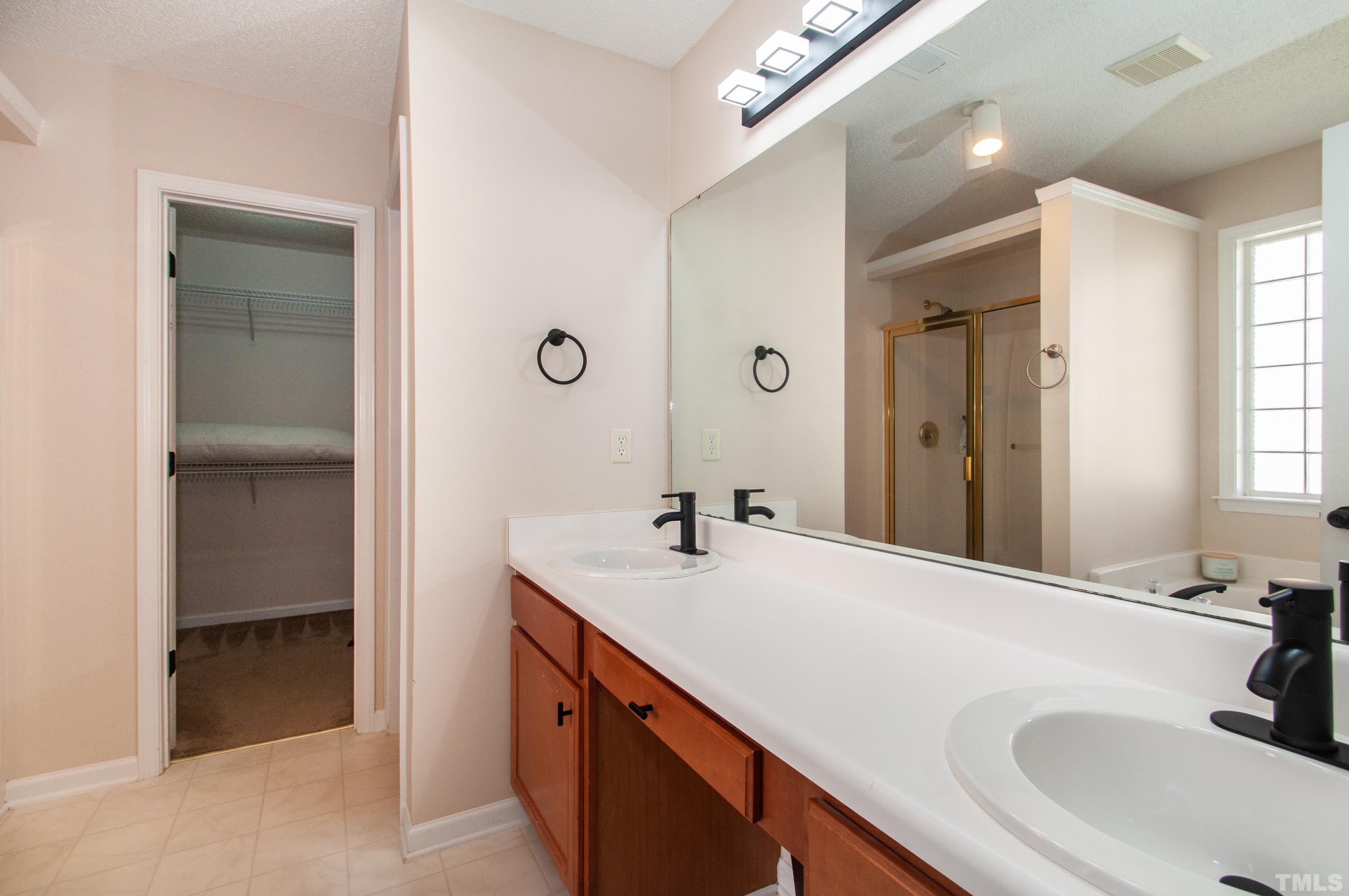 4617 Dresden Village Drive Raleigh, NC 27604 - Photo 17 of 33 a bathroom with a sink and a mirror