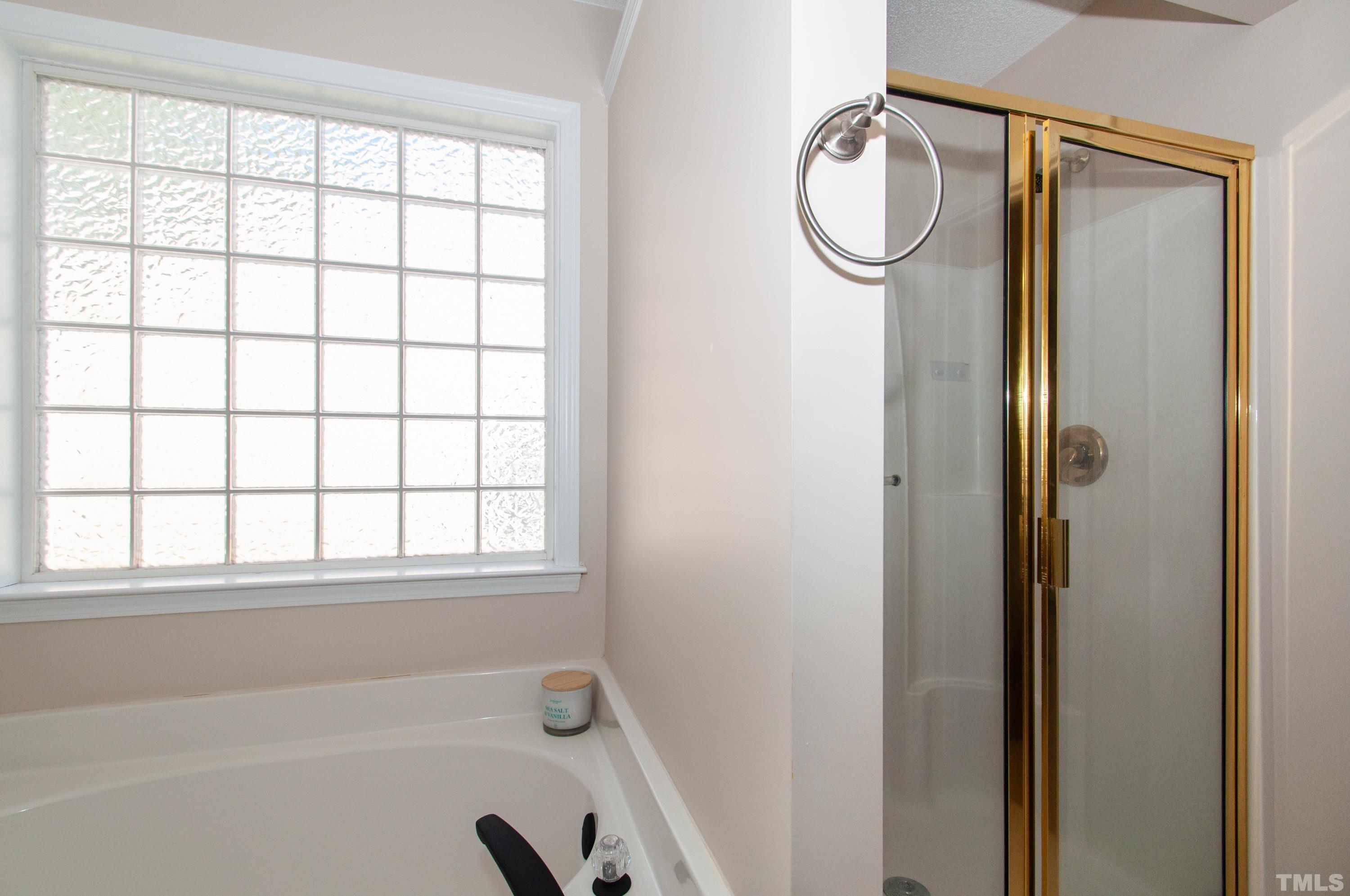 4617 Dresden Village Drive Raleigh, NC 27604 - Photo 18 of 33 a bathroom with a granite countertop bathtub and a shower
