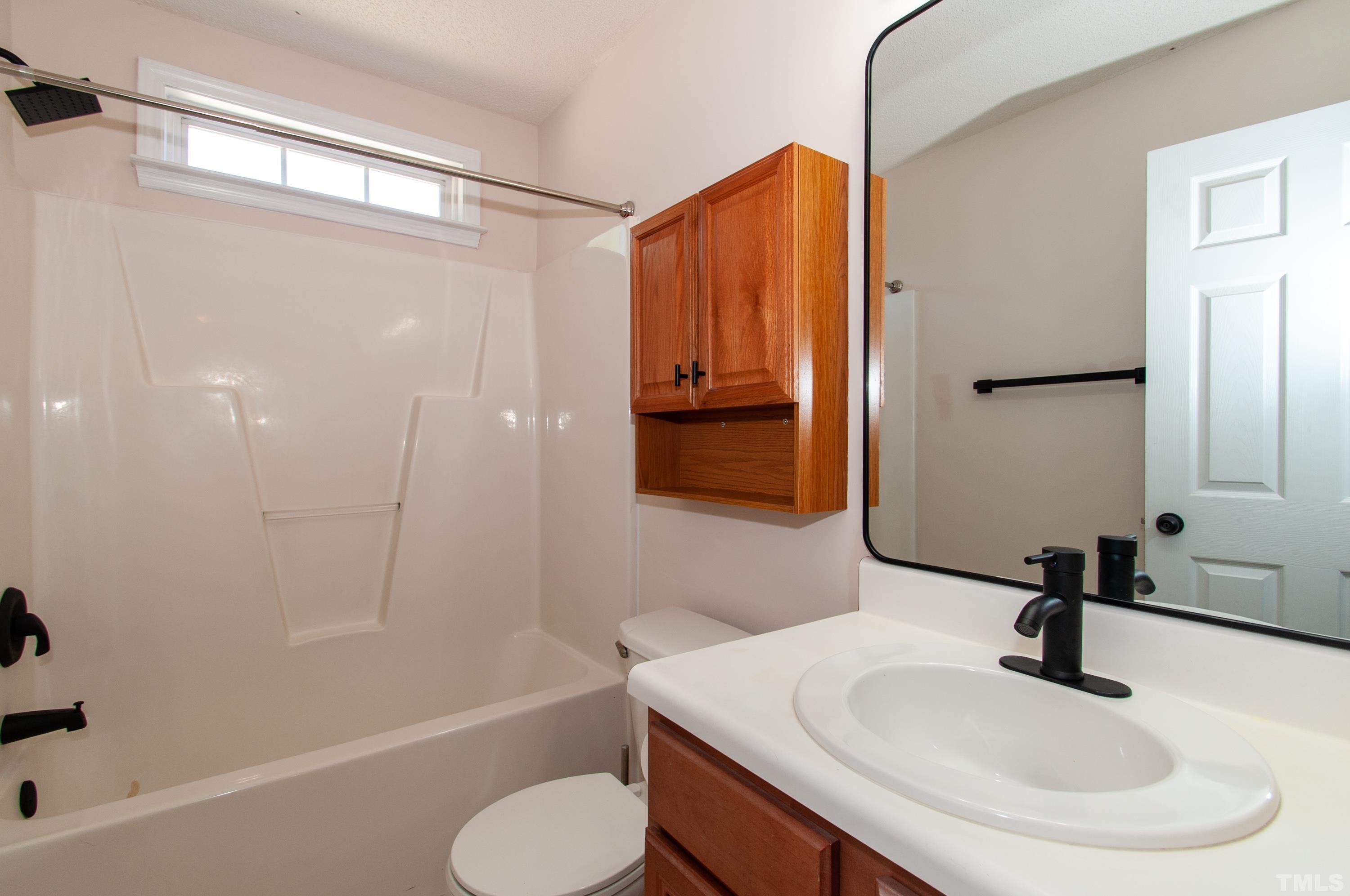 4617 Dresden Village Drive Raleigh, NC 27604 - Photo 25 of 33 a bathroom with a sink toilet and shower