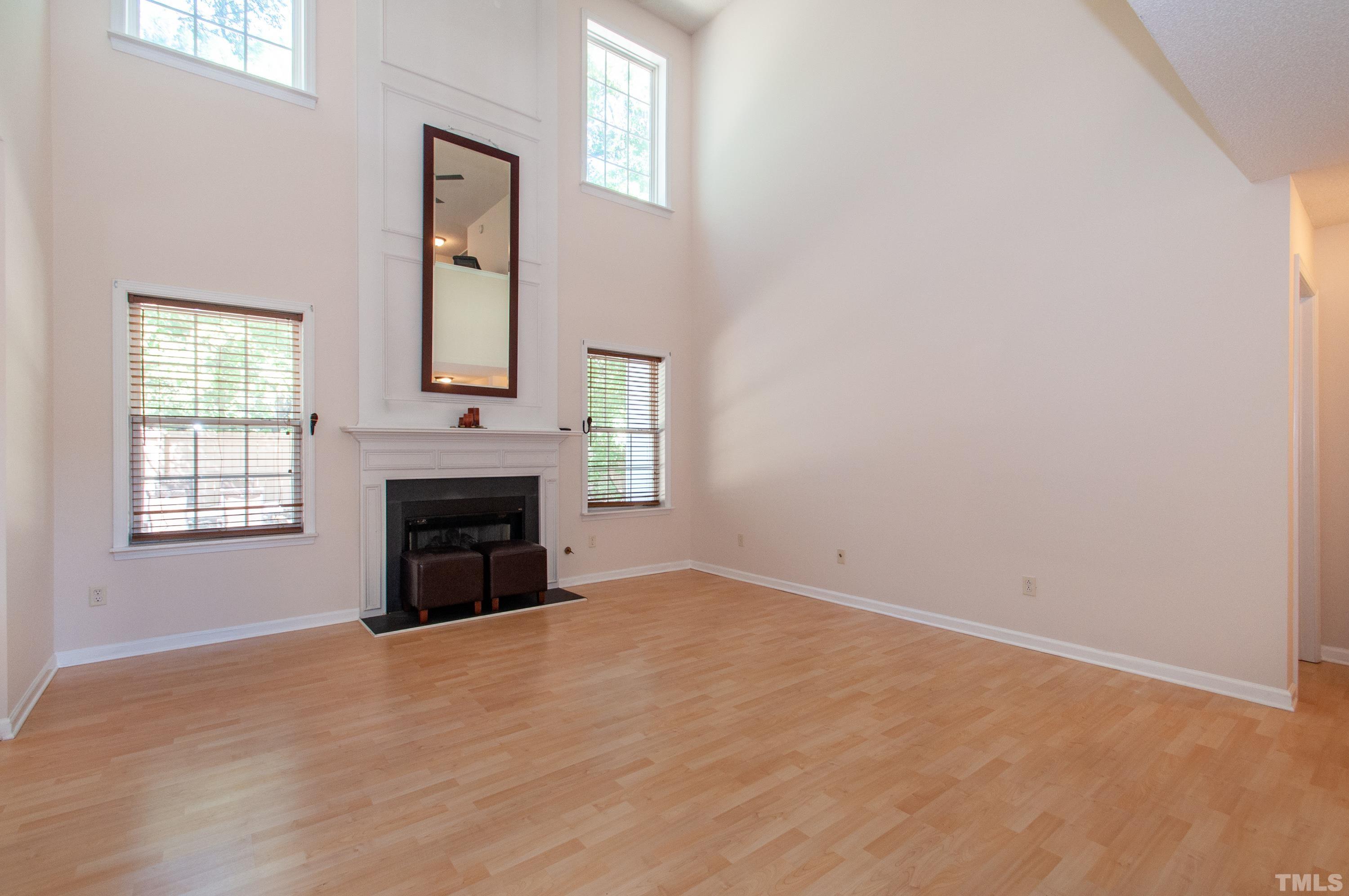 4617 Dresden Village Drive Raleigh, NC 27604 - Photo 3 of 33 an empty room with windows and fireplace
