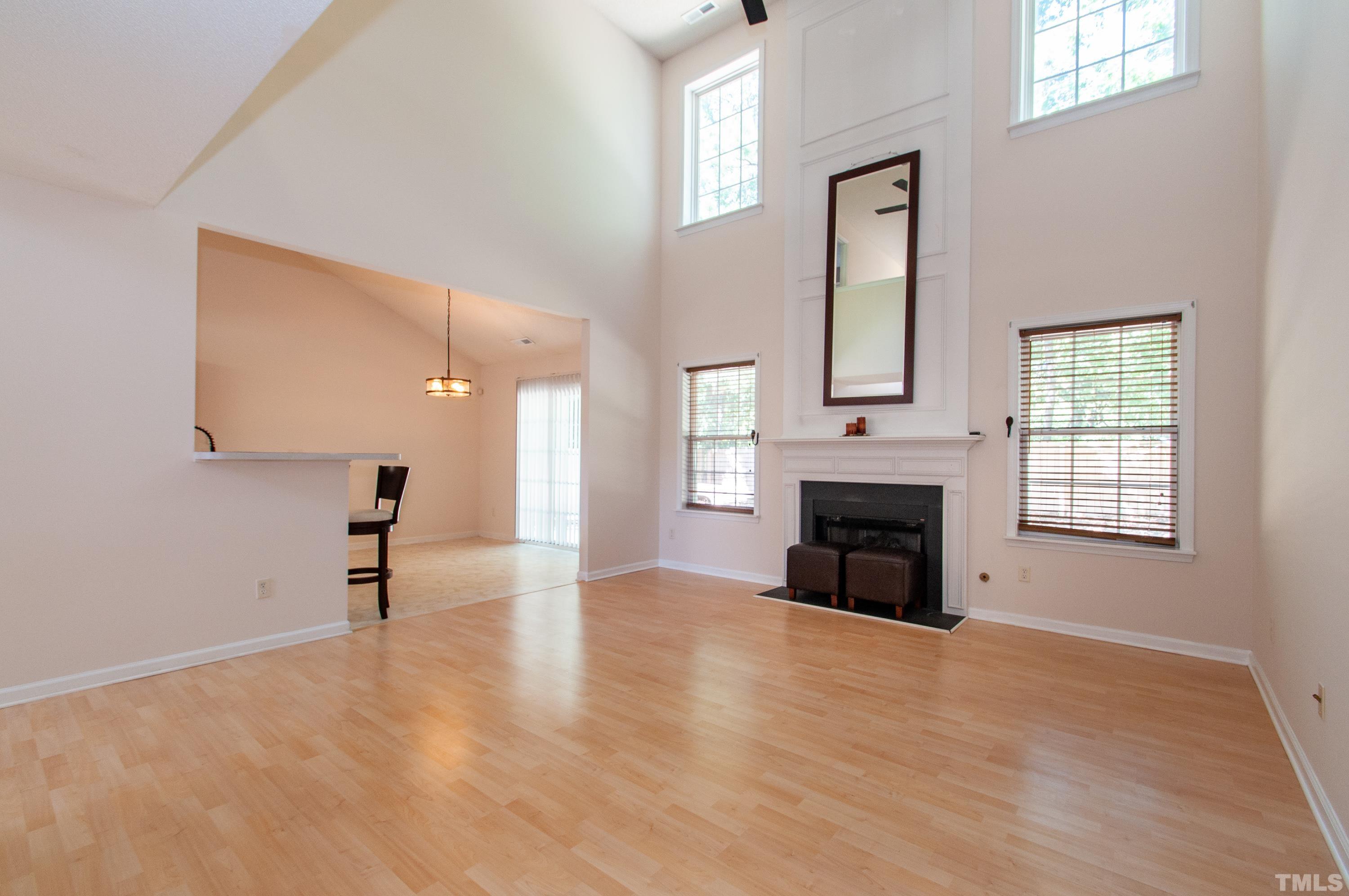 4617 Dresden Village Drive Raleigh, NC 27604 - Photo 4 of 33 an empty room with windows and fireplace