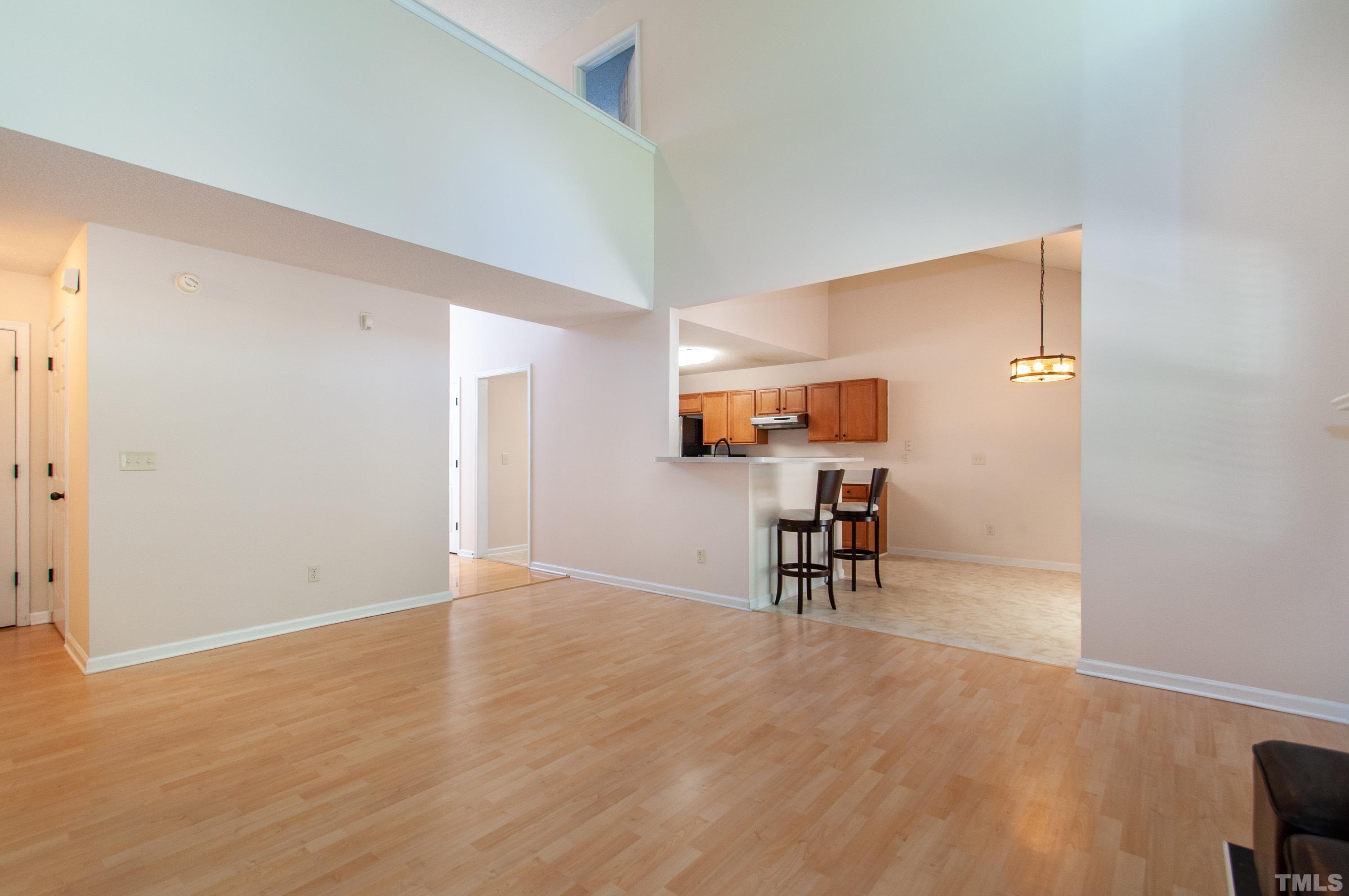 4617 Dresden Village Drive Raleigh, NC 27604 - Photo 5 of 33 a view of a livingroom and a kitchen with wooden floor