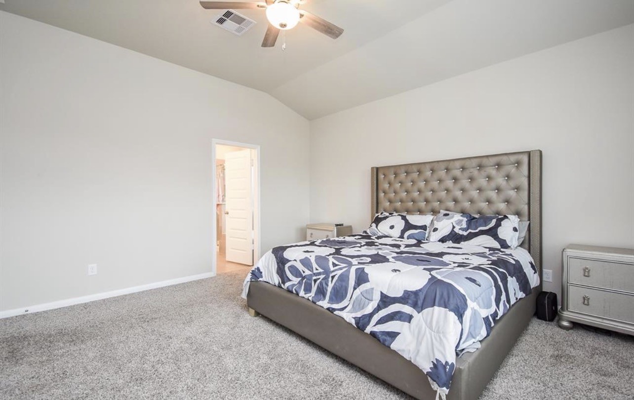 6927 Ventura Drive Rosharon, TX 77583 - Photo 14 of 24 a bedroom with a bed and a chandelier