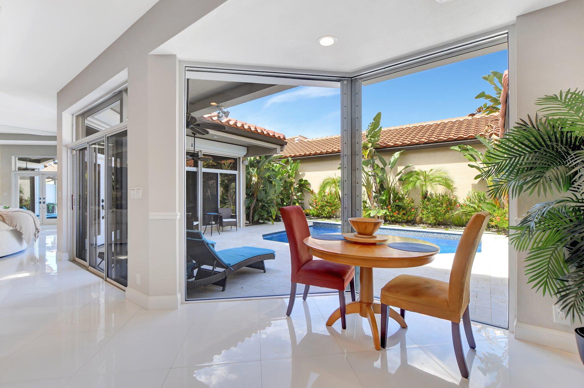 23164 Via Stel Boca Raton, FL 33433 - Photo 12 of 31 a dining room with furniture and a floor to ceiling window