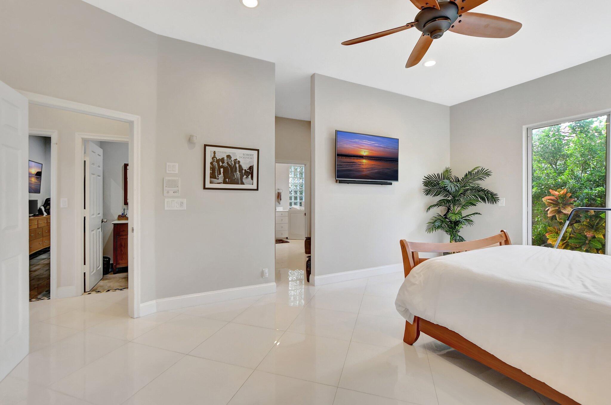 23164 Via Stel Boca Raton, FL 33433 - Photo 16 of 31 a bedroom with a bed and a flat screen tv