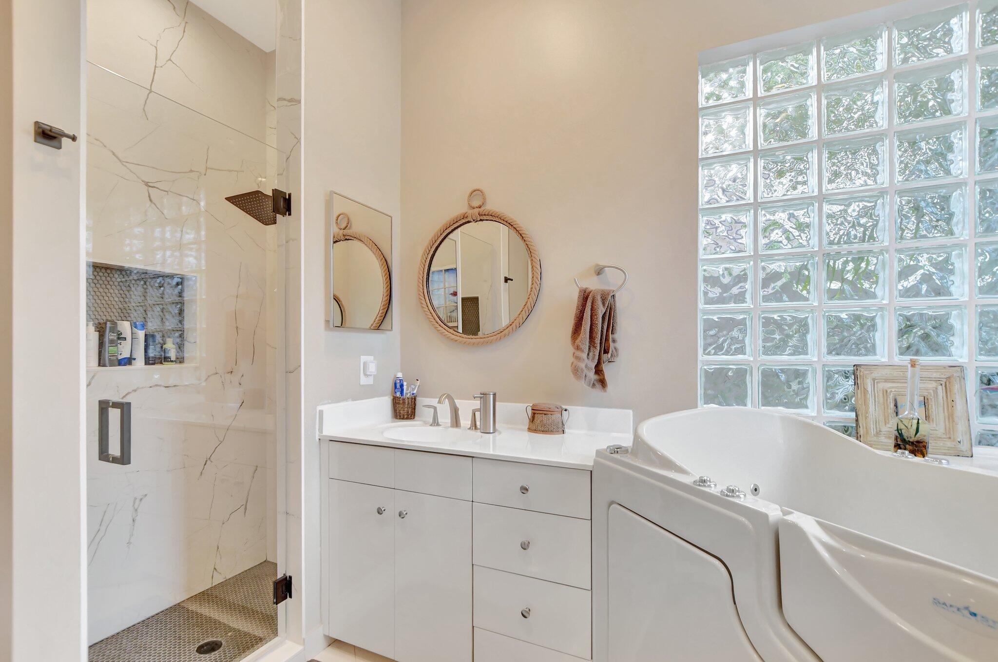 23164 Via Stel Boca Raton, FL 33433 - Photo 19 of 31 a bathroom with a sink and a mirror