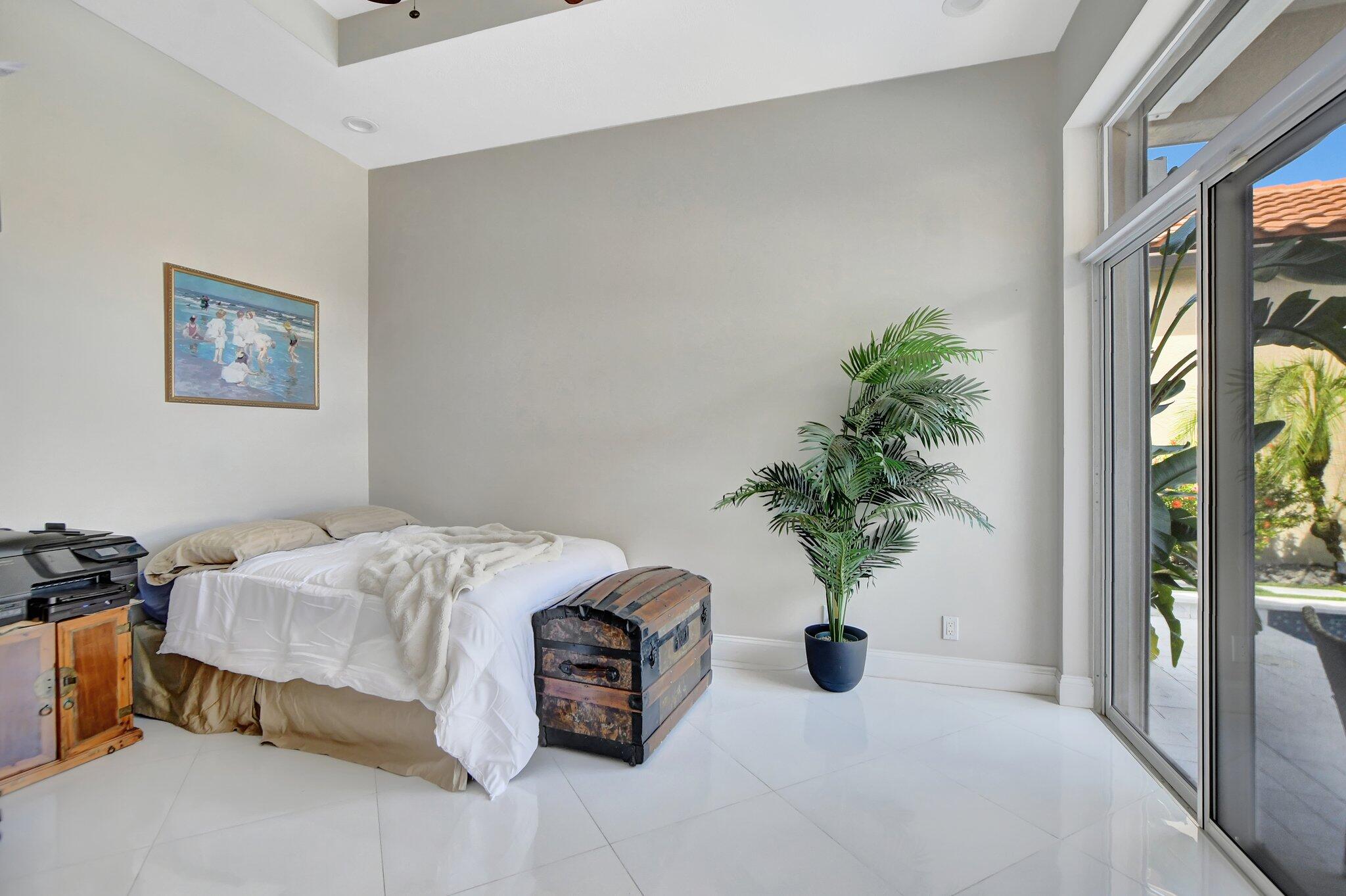 23164 Via Stel Boca Raton, FL 33433 - Photo 25 of 31 a bedroom with a bed and a potted plant