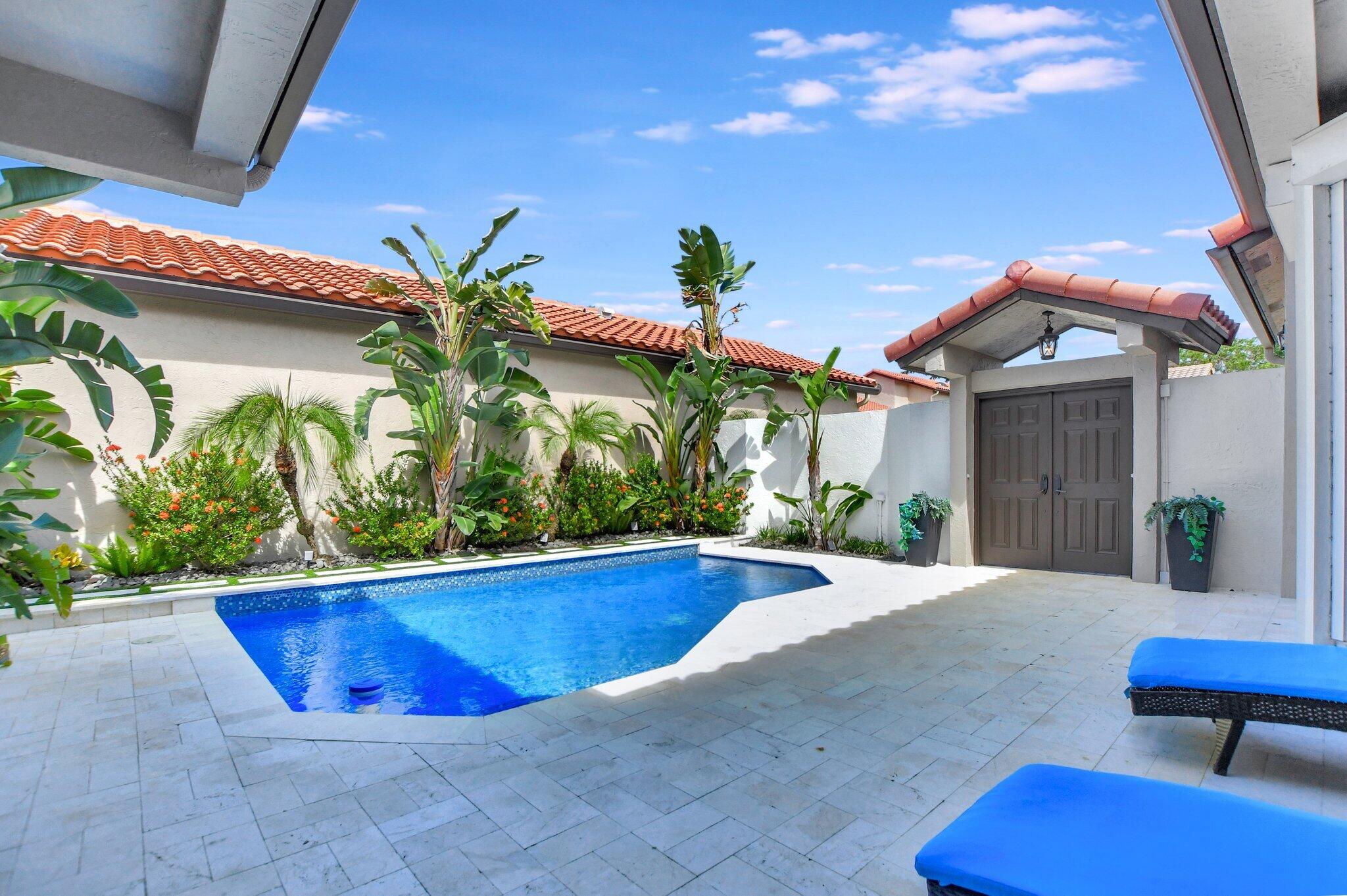 23164 Via Stel Boca Raton, FL 33433 - Photo 29 of 31 a view of a swimming pool with potted plants