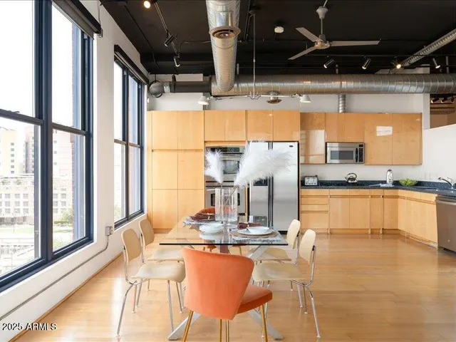 a kitchen with stainless steel appliances granite countertop a sink and cabinets