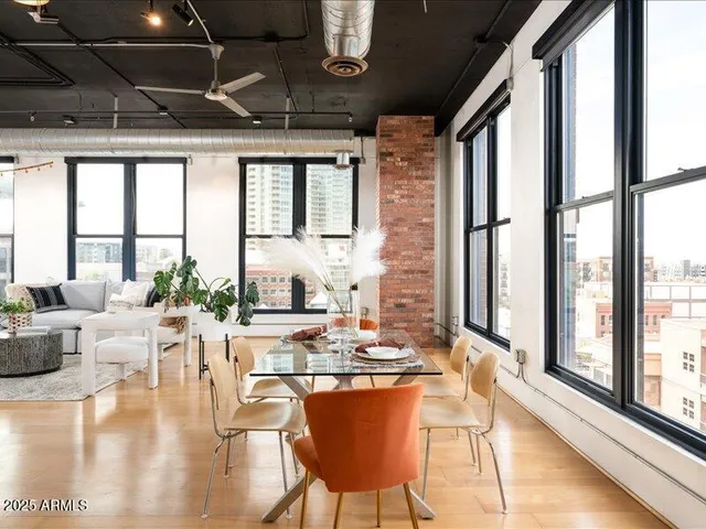 a dining room with furniture a chandelier and wooden floor