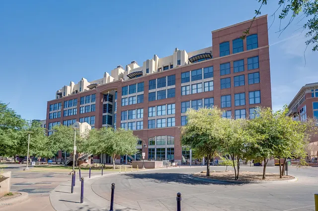 a view of a building with garden and sitting area