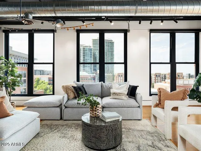 a living room with furniture and a floor to ceiling window