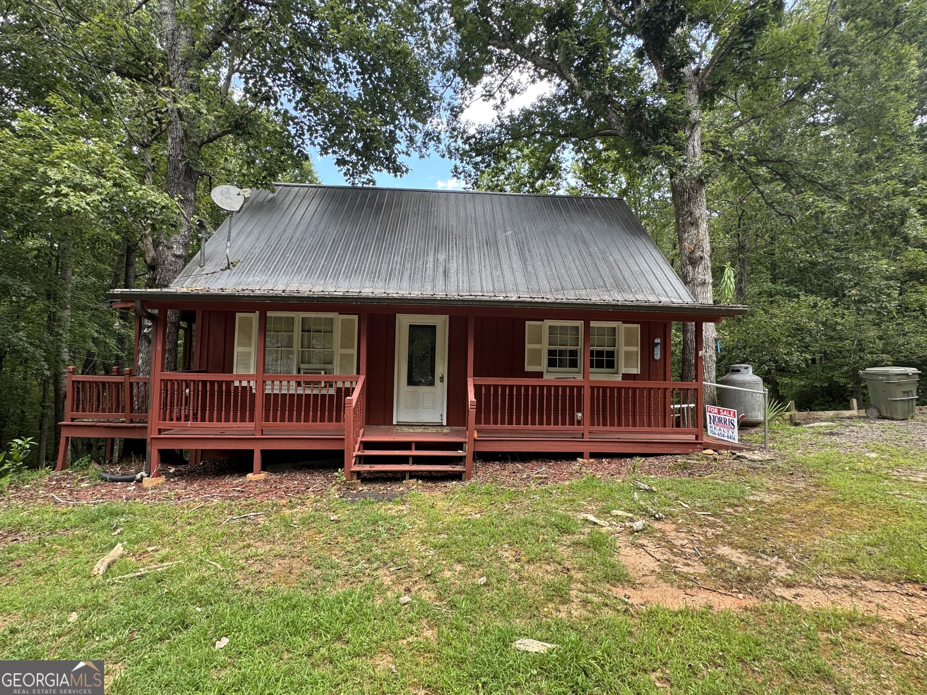 86 White Pines Road Cleveland, GA 30528 - Photo 1 of 1 a front view of a house with a garden and deck