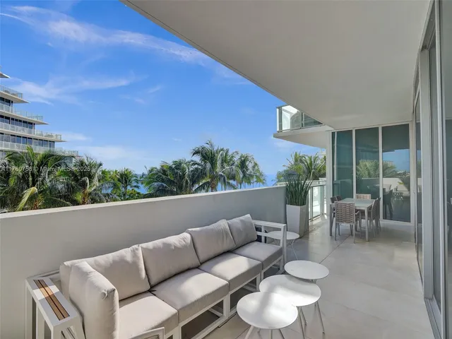 a view of balcony with furniture and potted plants