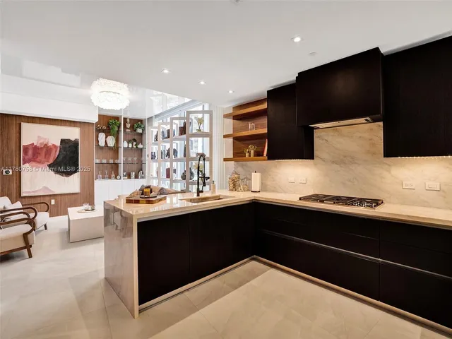 a kitchen with stainless steel appliances granite countertop a sink and a stove