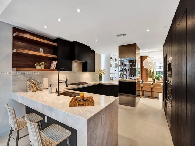 a kitchen with a table chairs refrigerator and microwave