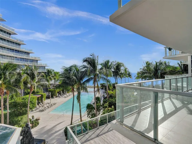a view of a palm plant from a balcony