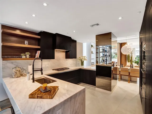 a kitchen with stainless steel appliances kitchen island granite countertop a sink and cabinets