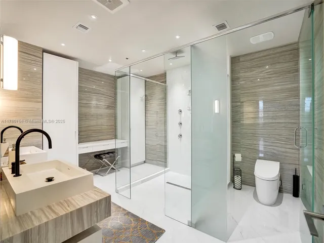 a bedroom with a bed and a large mirror