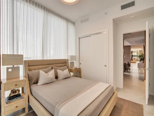 a bedroom with a bed and a potted plant