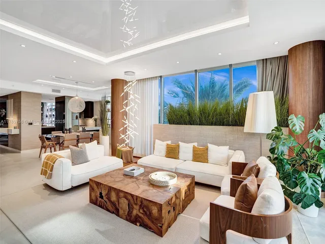 a living room with furniture fireplace and potted plant