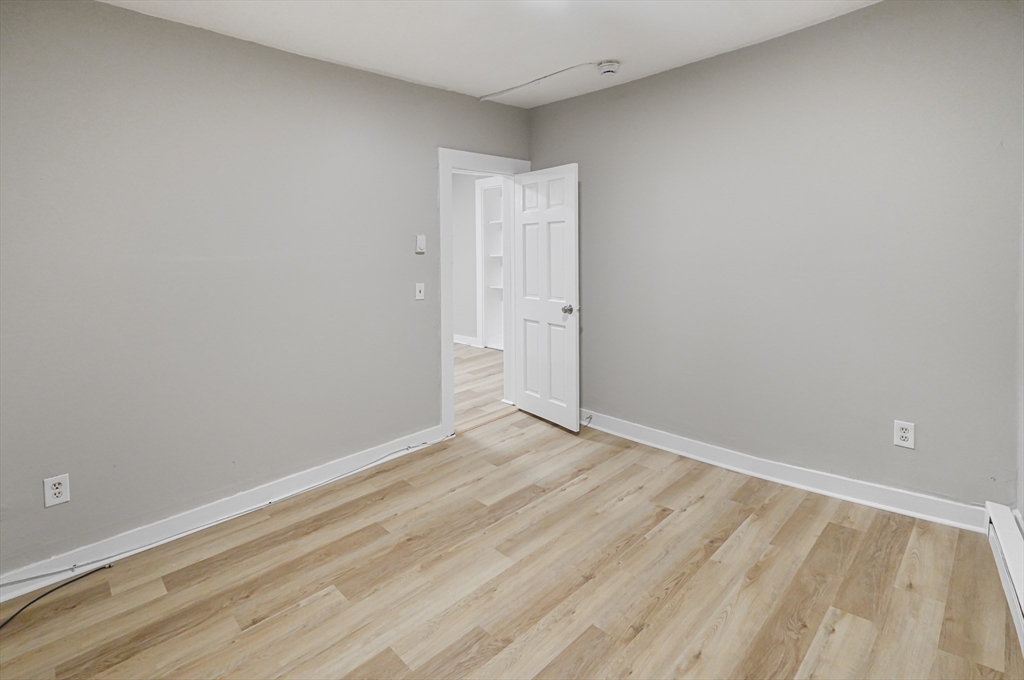 24 Charlton Street, Unit 7 Worcester, MA 01608 - Photo 12 of 17 a view of an empty room with wooden floor