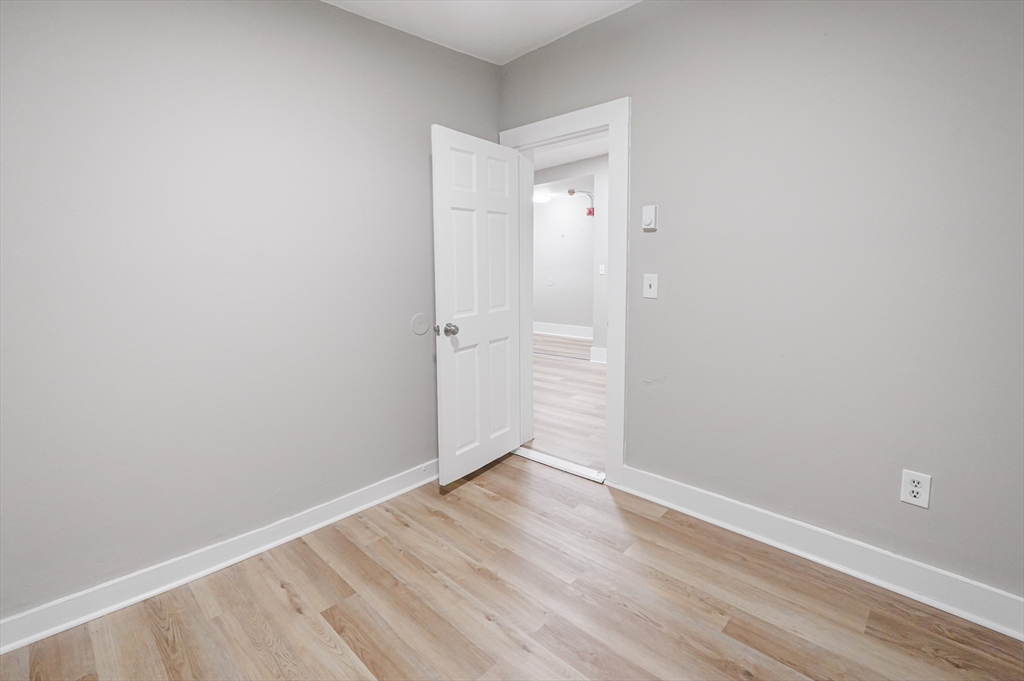 24 Charlton Street, Unit 7 Worcester, MA 01608 - Photo 16 of 17 a view of an empty room with wooden floor