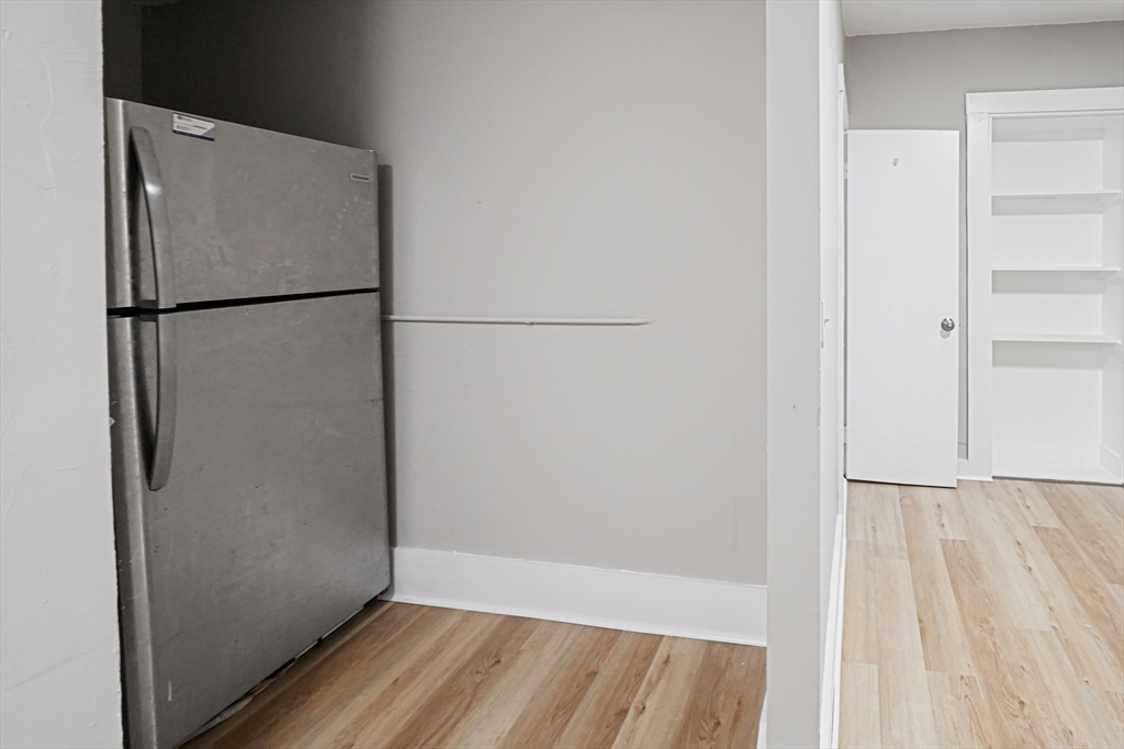 24 Charlton Street, Unit 7 Worcester, MA 01608 - Photo 3 of 17 a view of closet area with wooden floor