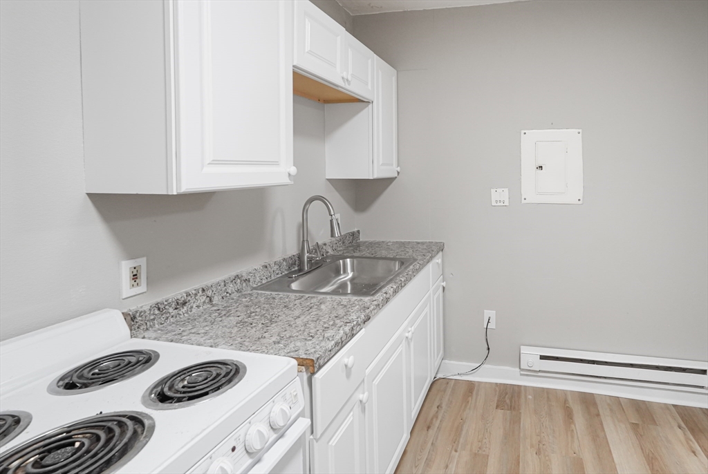 24 Charlton Street, Unit 7 Worcester, MA 01608 - Photo 6 of 17 a kitchen with a sink stove and cabinets
