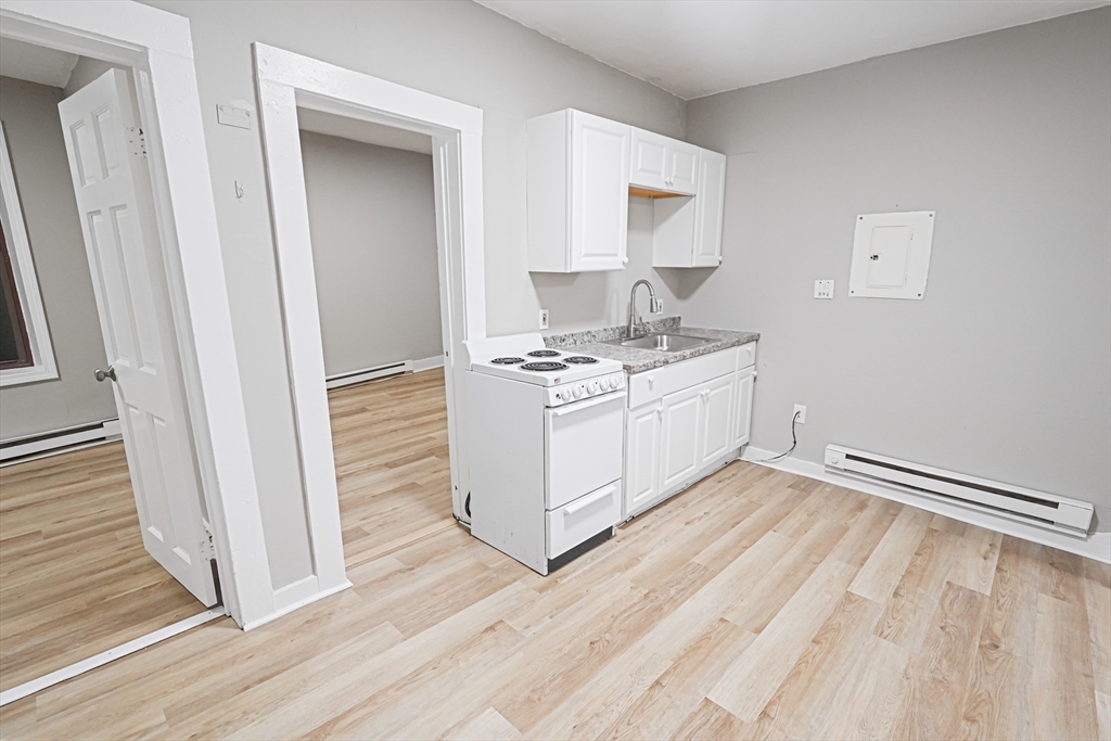 24 Charlton Street, Unit 7 Worcester, MA 01608 - Photo 7 of 17 a kitchen with a sink stove and cabinets