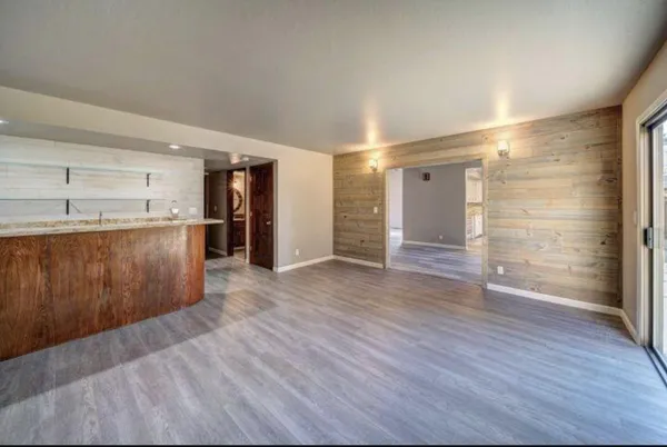 a view of a room with wooden floor and a window