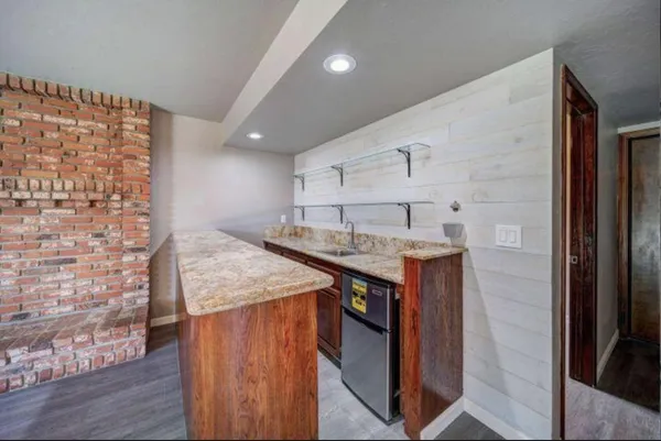 a kitchen with a sink and a refrigerator