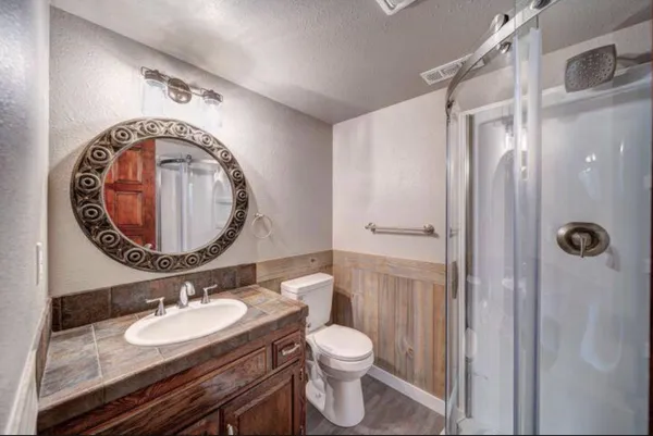 a bathroom with a toilet a sink and a mirror