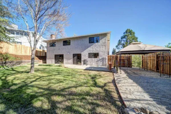 a view of a backyard with wooden fence