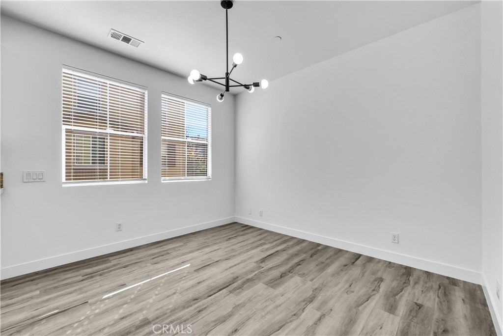 8415 Kendra Loop Orange, CA 92867 - Photo 16 of 36 a view of empty room with wooden floor fan and window