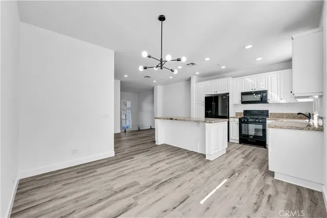 a view of an empty room and wooden floor