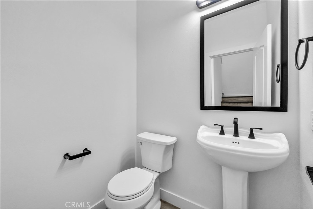 8415 Kendra Loop Orange, CA 92867 - Photo 18 of 36 a bathroom with a toilet sink and mirror