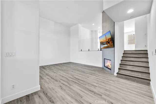 a view of kitchen with granite countertop cabinets and refrigerator