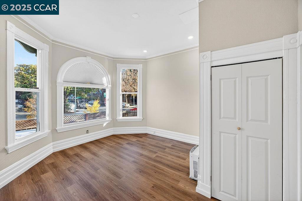 3229 Elm Street Oakland, CA 94609 - Photo 5 of 18 a view of an empty room with a window and wooden floor