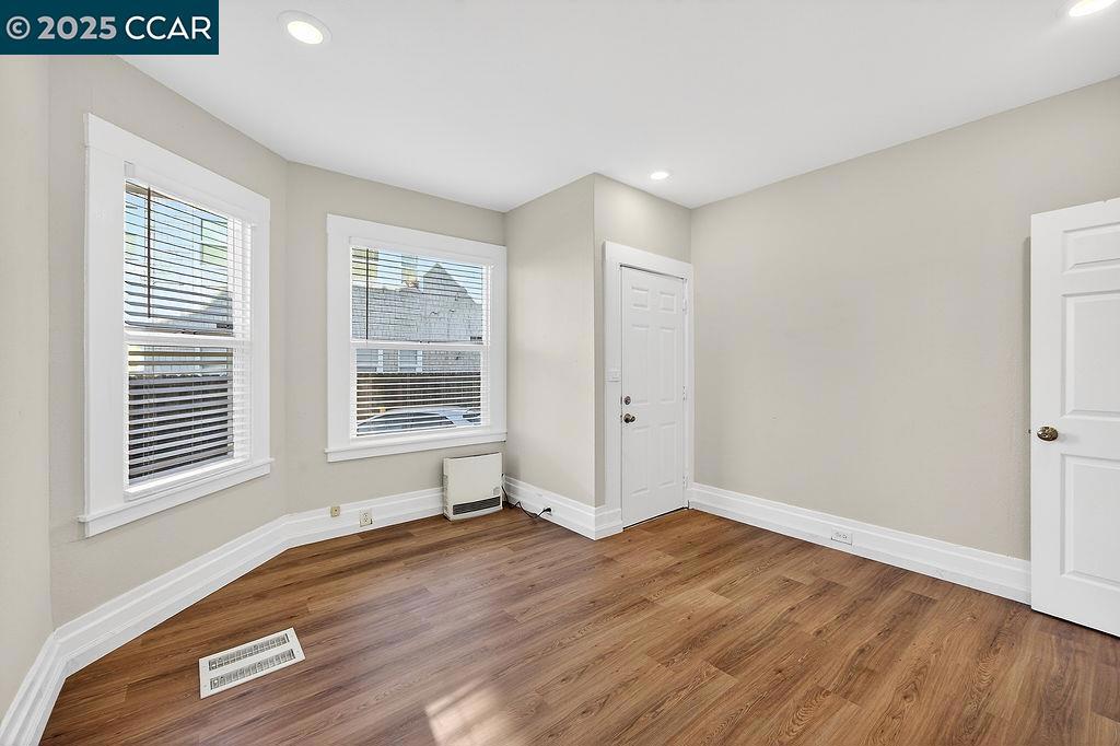 3229 Elm Street Oakland, CA 94609 - Photo 6 of 18 a view of an empty room with wooden floor and a window