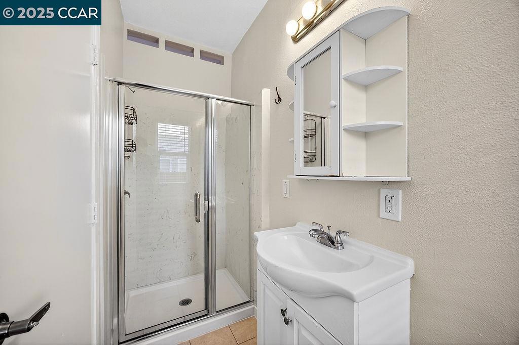 3229 Elm Street Oakland, CA 94609 - Photo 8 of 18 a bathroom with a sink mirror and shower