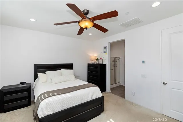 a en suite bathroom with a double vanity sink a mirror and shower
