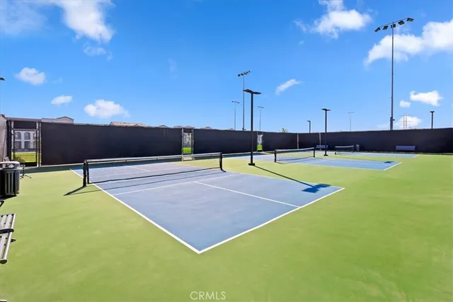 a patio with a table and chairs under an umbrella