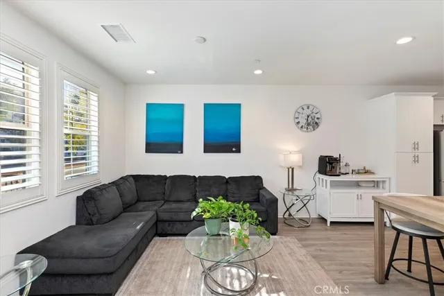 a living room with furniture potted plant and a flat screen tv